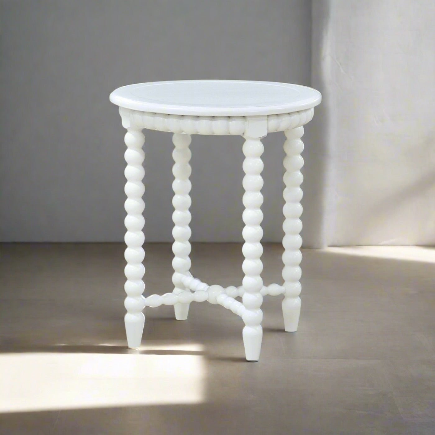 Elegant white end table in bright room, perspective view.