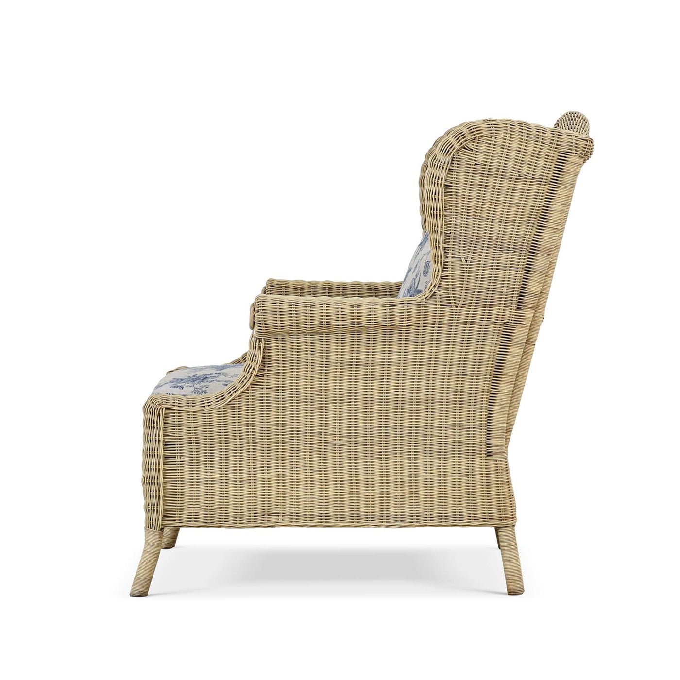 Side profile of rattan wingback armchair.