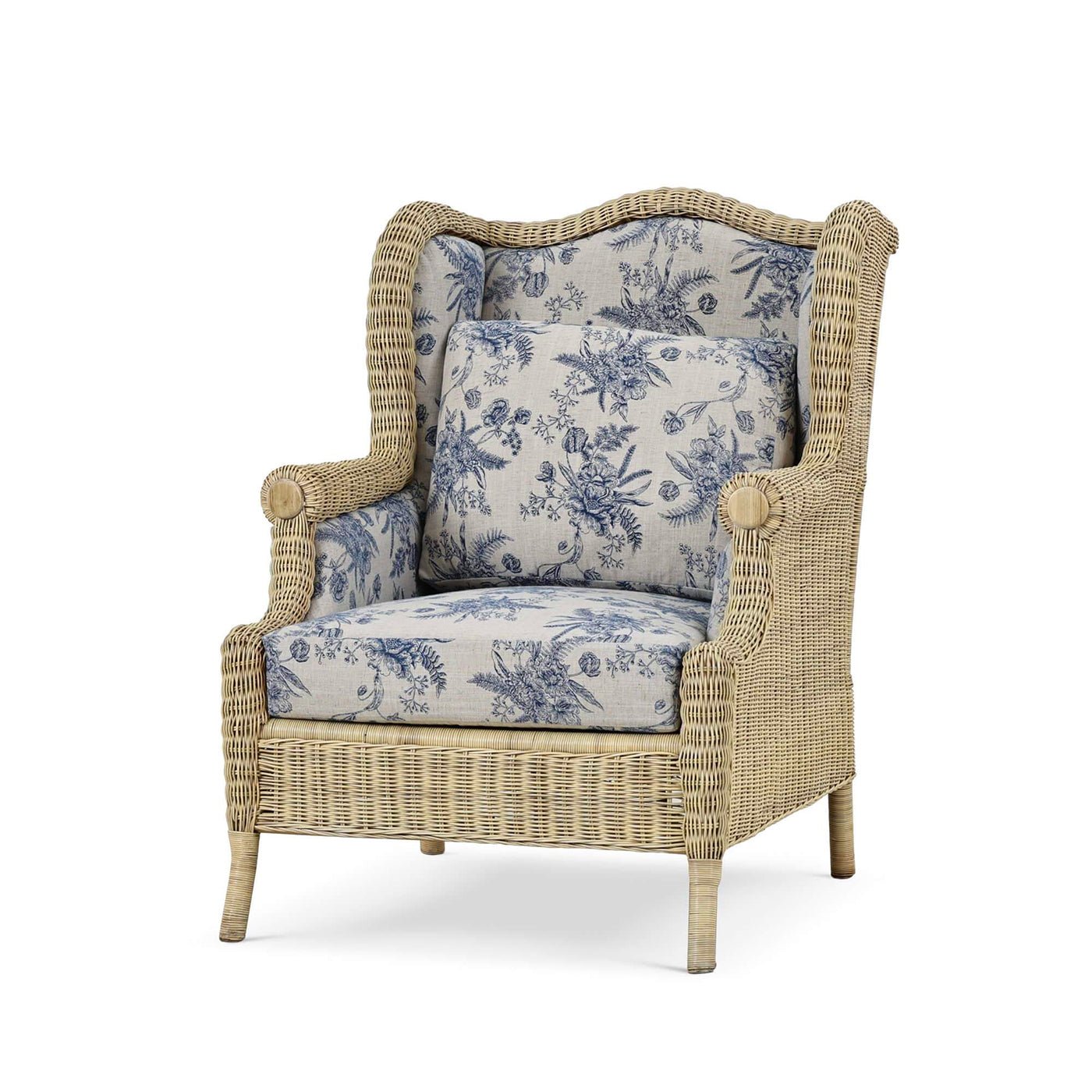 Rattan wingback armchair with blue floral cushions.