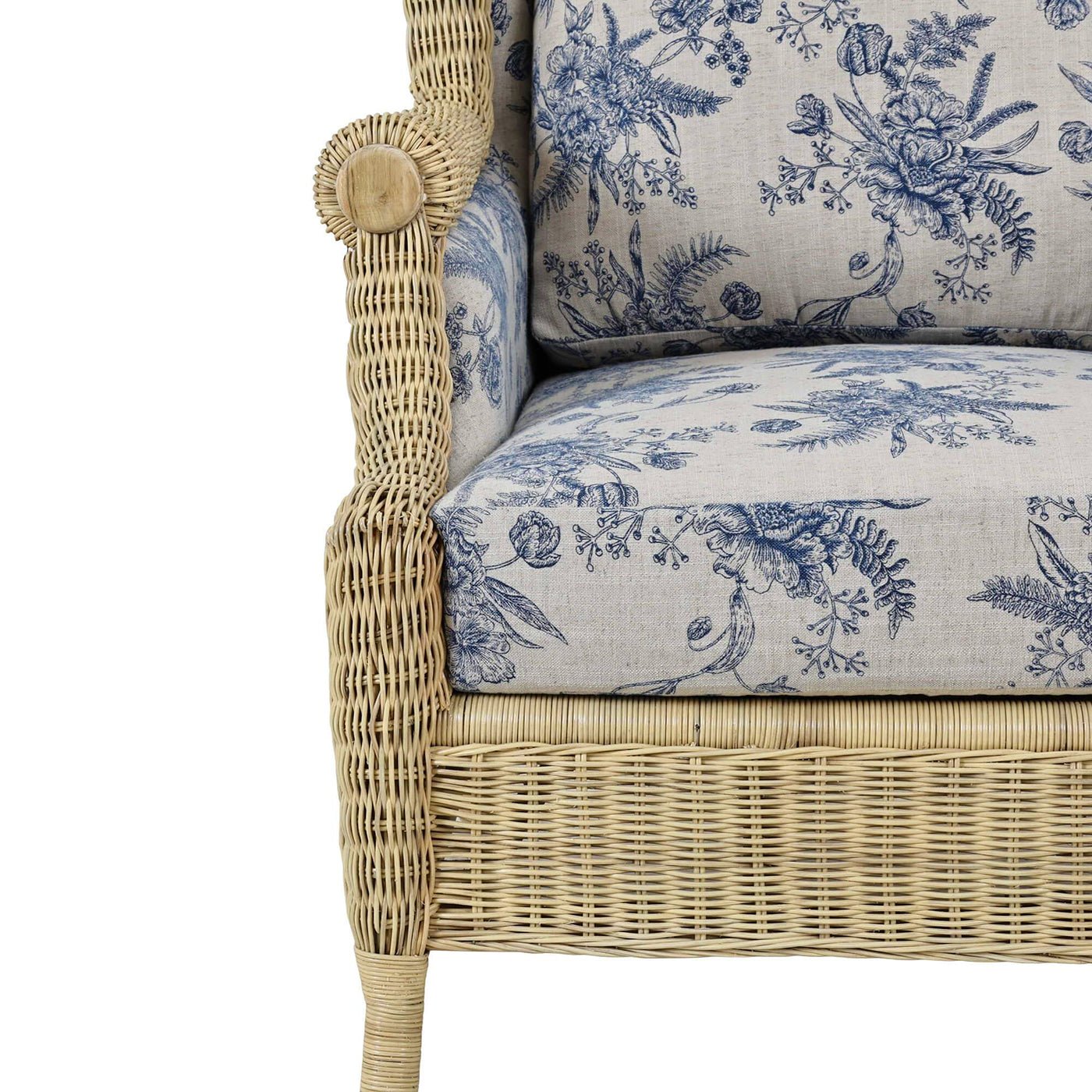 Armrest and seat detail of wicker wingback chair.