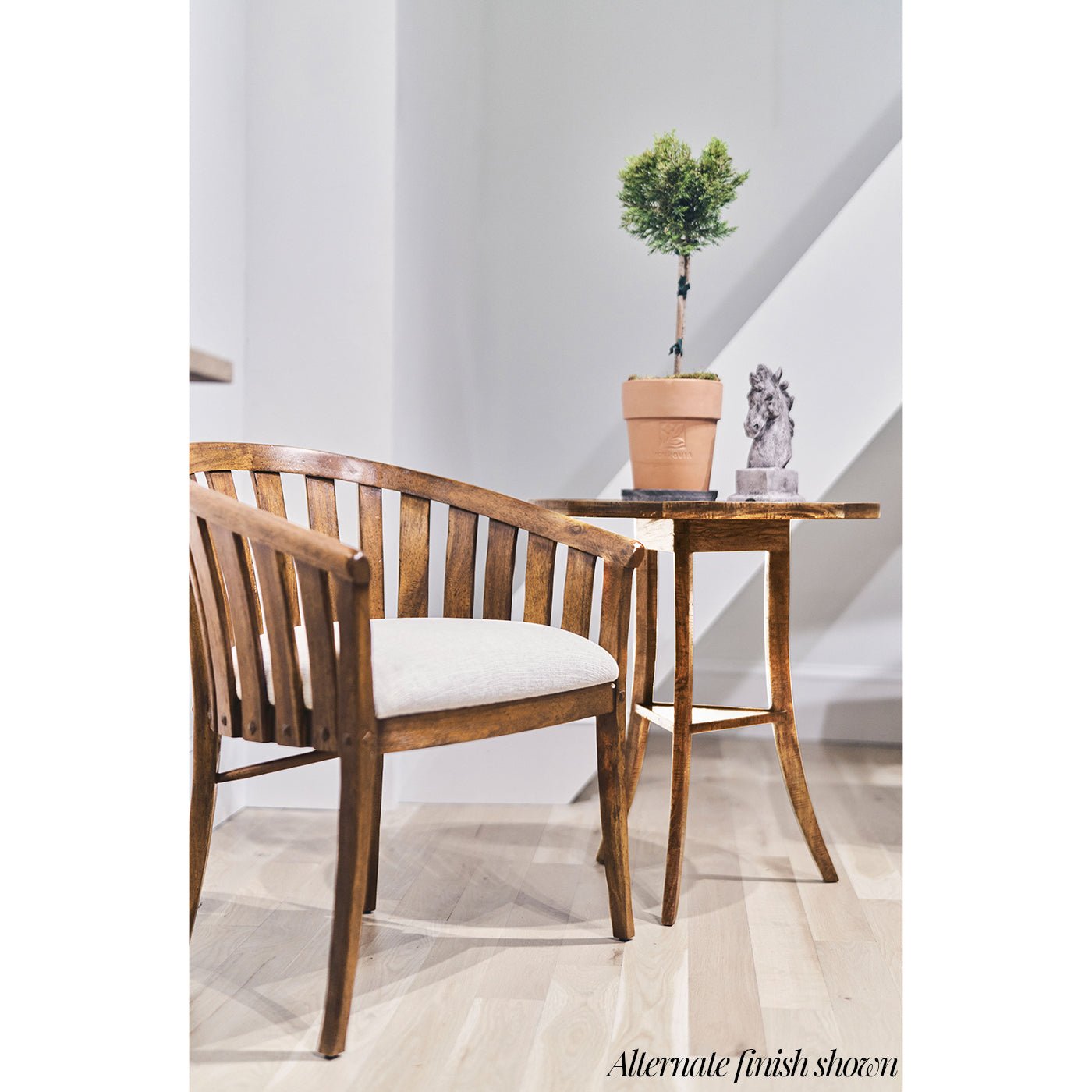 Wooden end table next to chair in bright room.