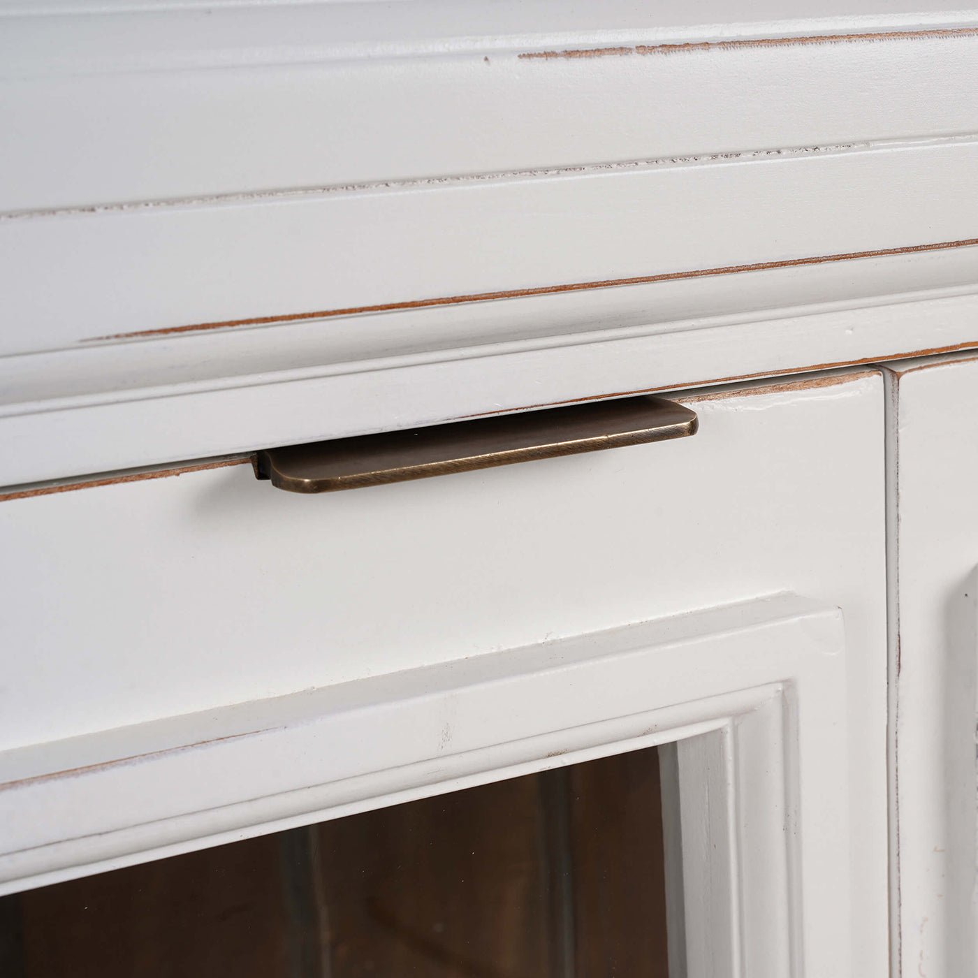 Close-up of credenza door handle and glass detailing.