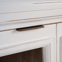 Close-up of credenza door handle and glass detailing.