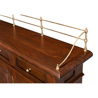 Close-up of brass railing on walnut buffet sideboard.