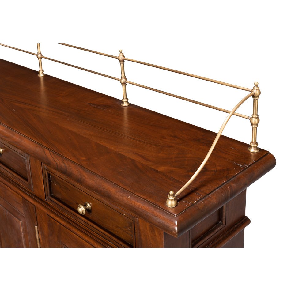 Close-up of brass railing on walnut buffet sideboard.