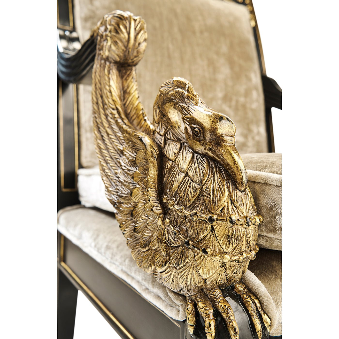 Close-up carved gold detail on French Empire armchair.