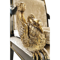 Close-up carved gold detail on French Empire armchair.