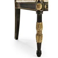 Leg detail of French Empire armchair with gold carvings.
