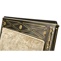 Elegant French Empire armchair headrest detailing, intricate carvings.