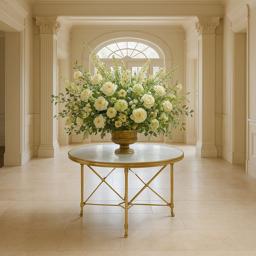 Ornate center table with floral arrangement, bright hallway.