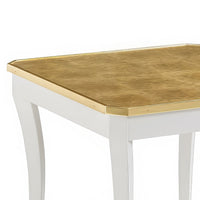 Close-up of gold tabletop with white curved legs.