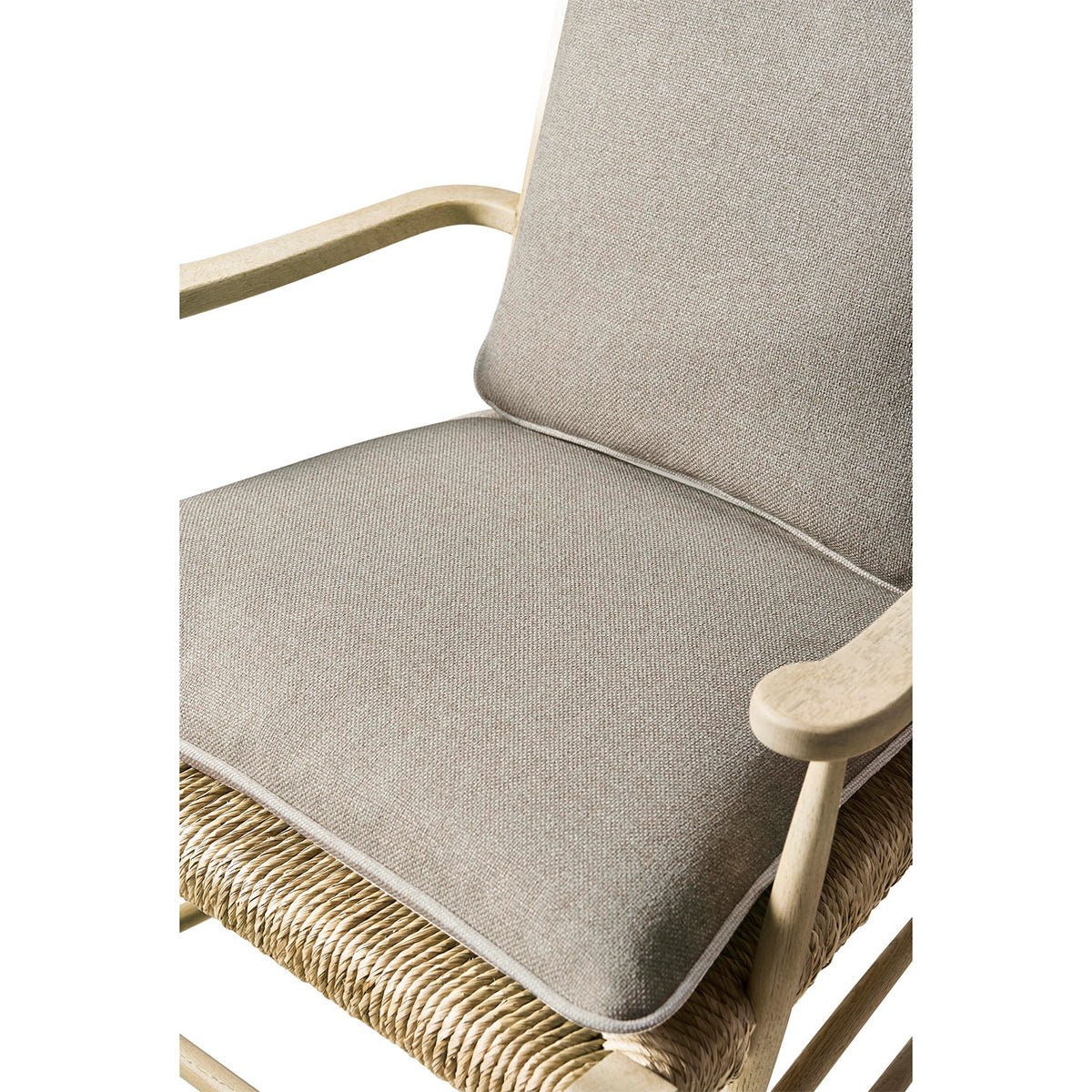 Close-up of cushioned seat on ladderback arm chair.