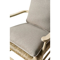 Close-up of cushioned seat on ladderback arm chair.