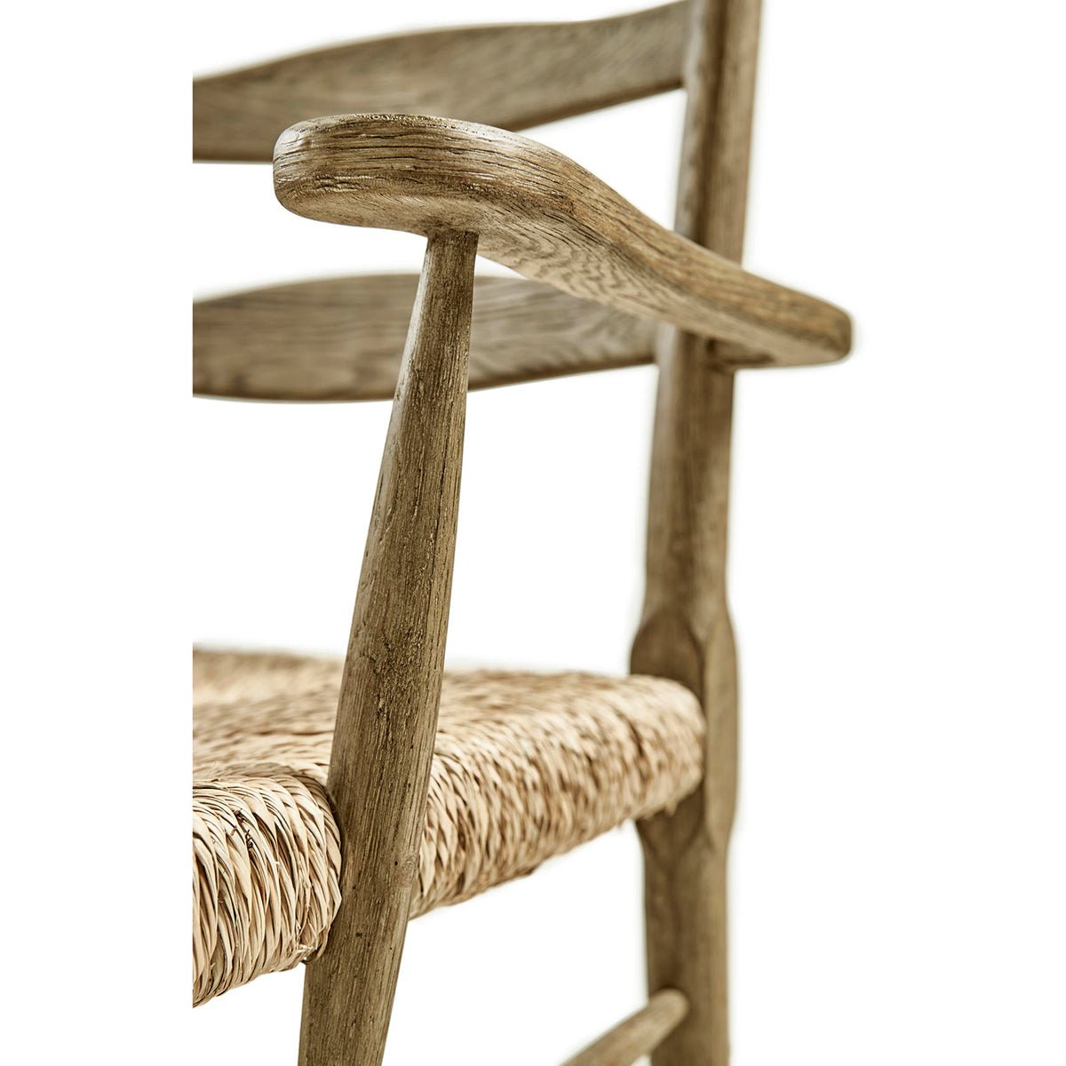 Close-up of armrest and woven seat of chair.
