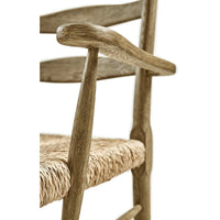 Close-up of armrest and woven seat of chair.