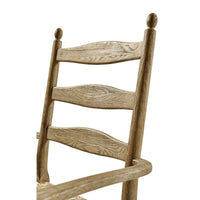 Close-up of ladderback chair backrest detail and texture.