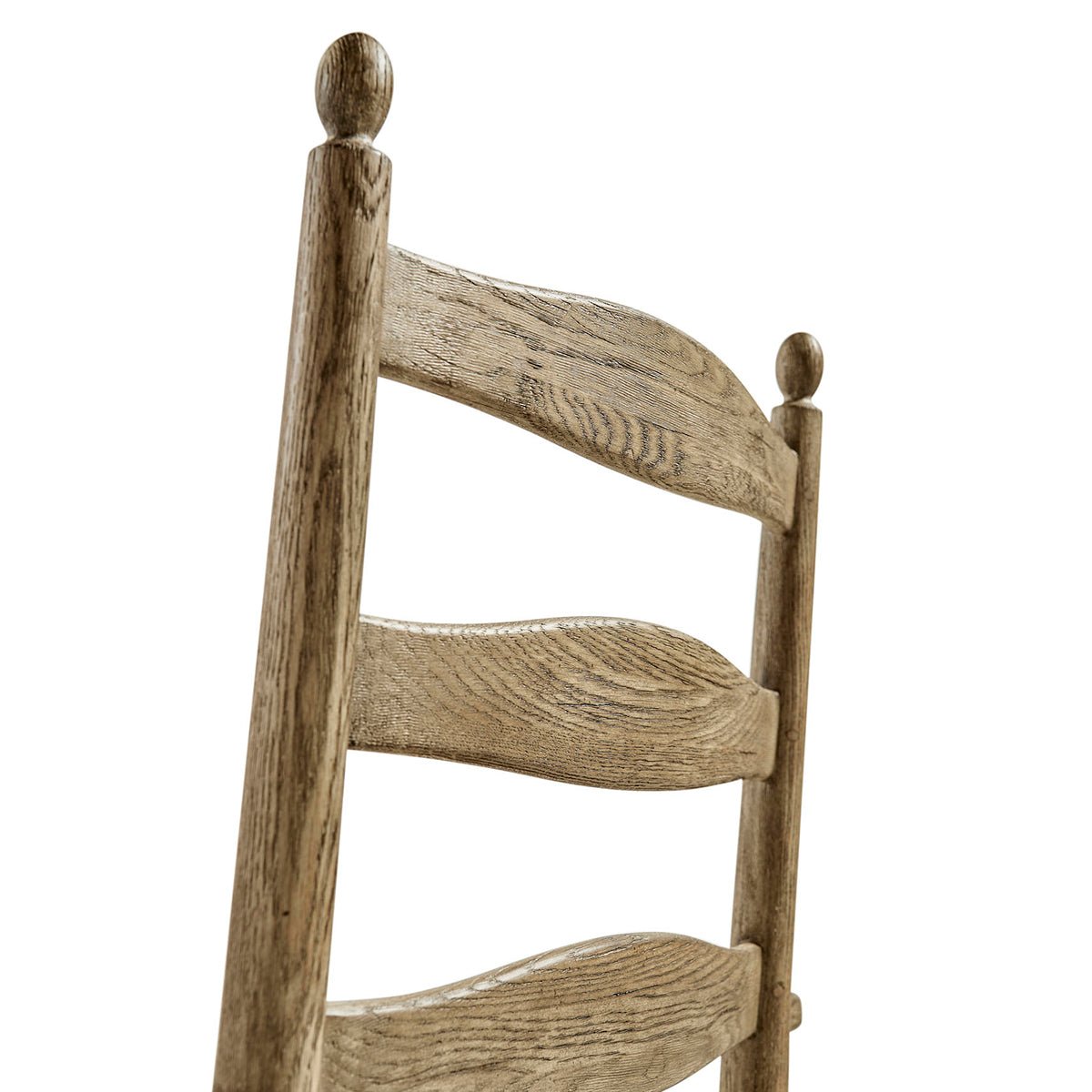 Ladderback and finial detail on chair back.