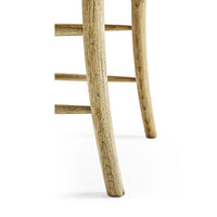Wooden chair leg close-up, natural texture visible.