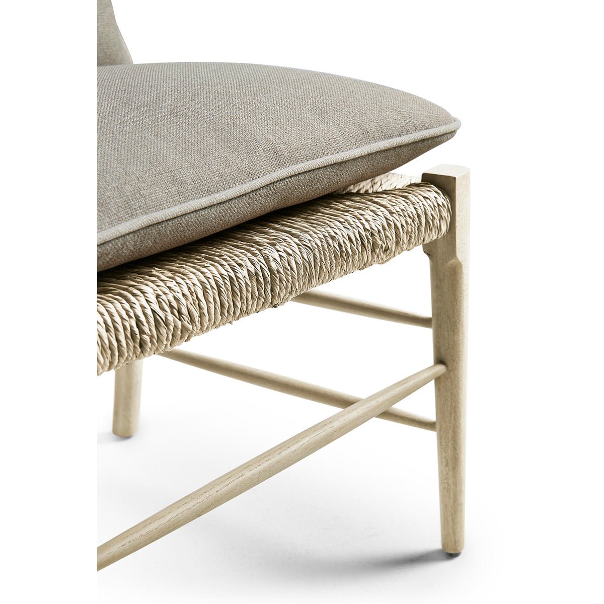 Chair with woven seat and cushion, side detail.
