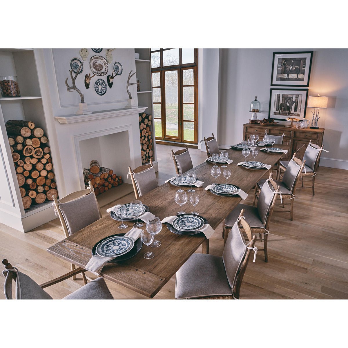 Dining table set with ladderback chairs and plates.