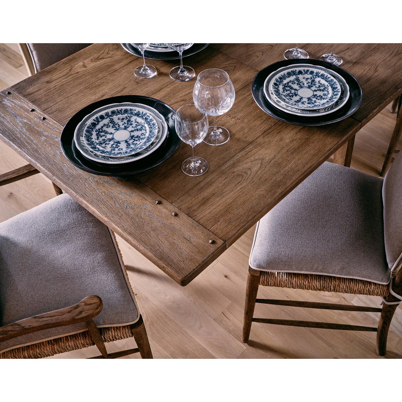 Set dining table with plates and glasses, close-up.