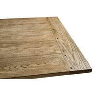 Corner close-up of wooden dining table extension.