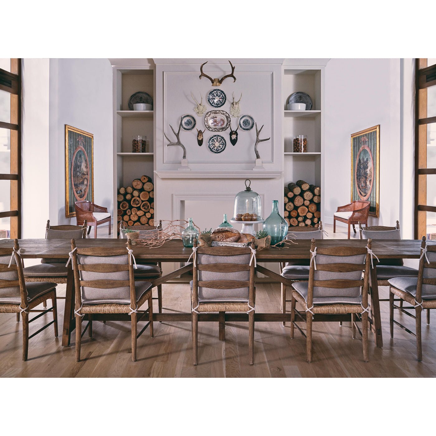 Dining table in decorated room with chairs, wide shot.