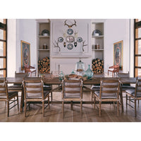 Dining table in decorated room with chairs, wide shot.