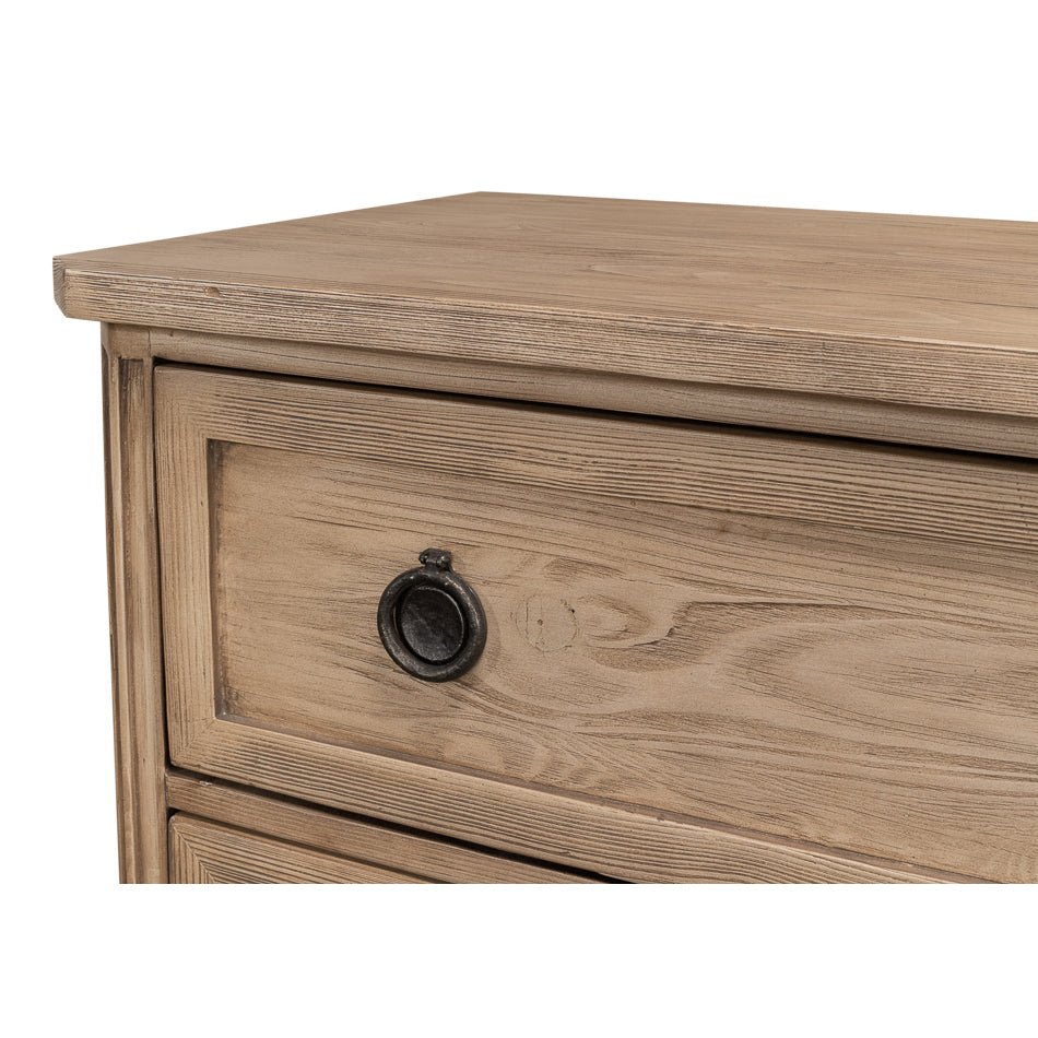 Close-up of drawer with round metal handle, oak dresser.