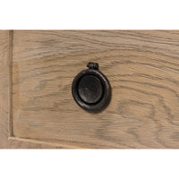 Detailed view of round black drawer knob.