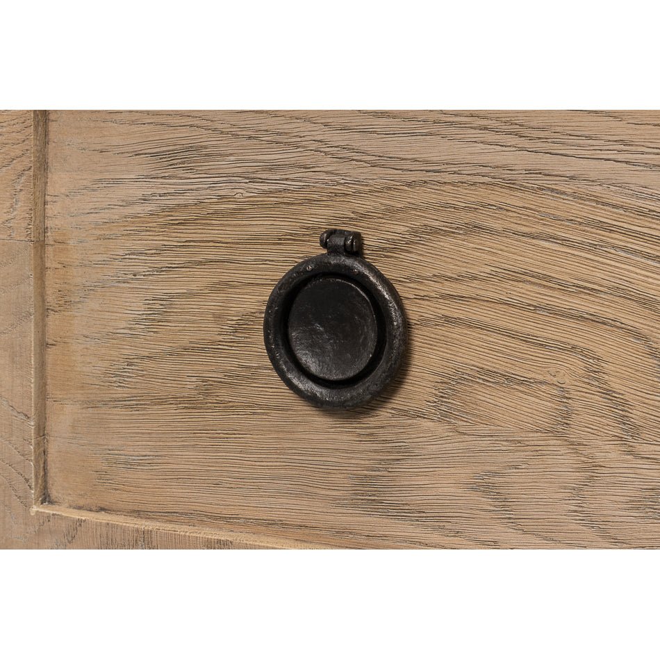 Detailed view of round black drawer knob.