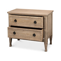 Drawers partially open on oak nightstand, side view.