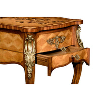 Open drawer with ornate handle on Louis XV table.