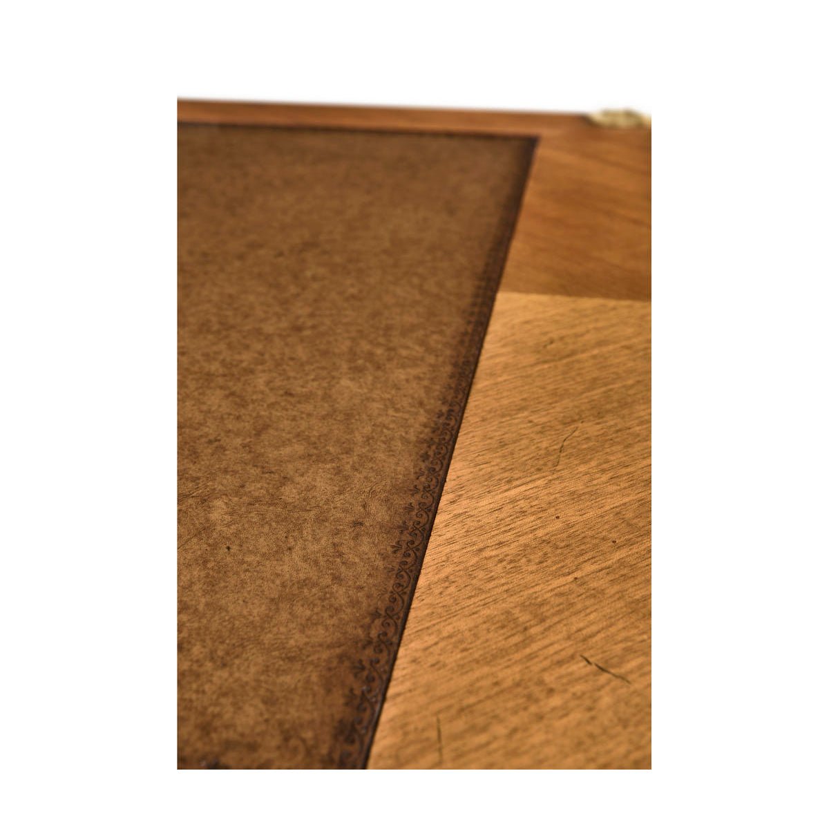 Close-up of writing desk's wooden surface texture and finish.