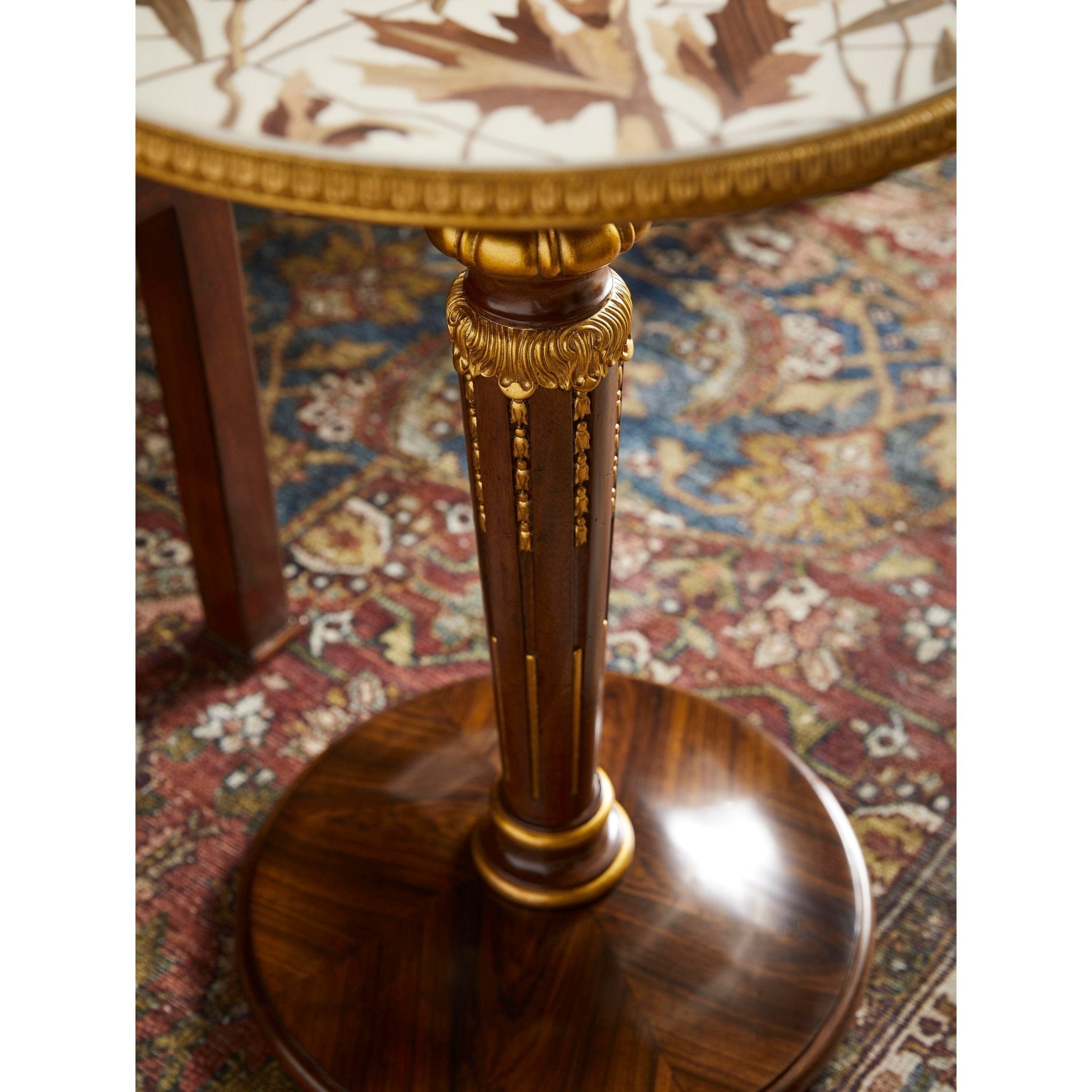 Detailed view of accent table’s ornate leg and base.