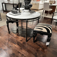 Zebra vanity stool near round table, stylish setting.
