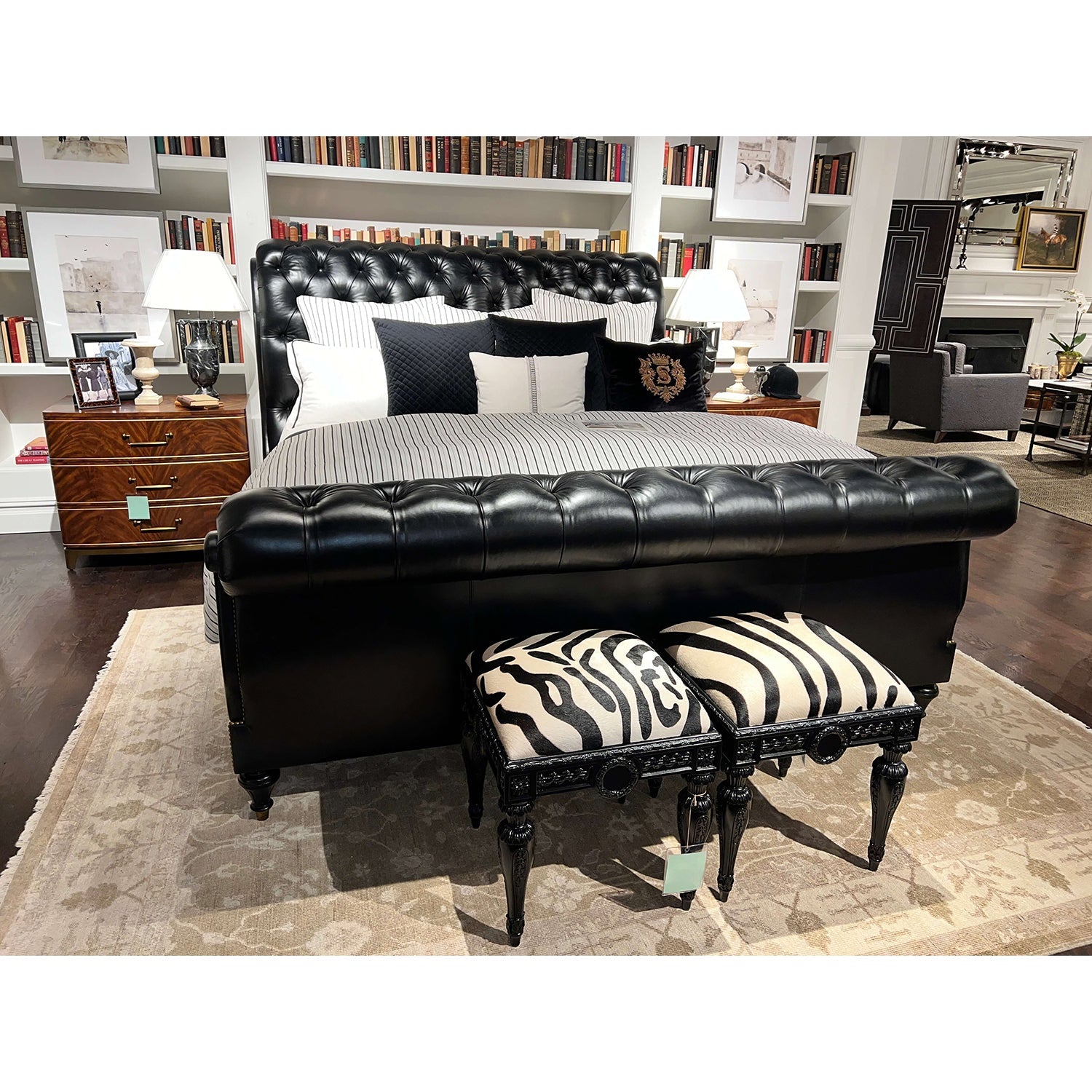 Bedroom with zebra vanity stools at bed's foot.