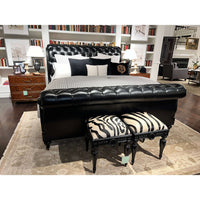 Bedroom with zebra vanity stools at bed's foot.