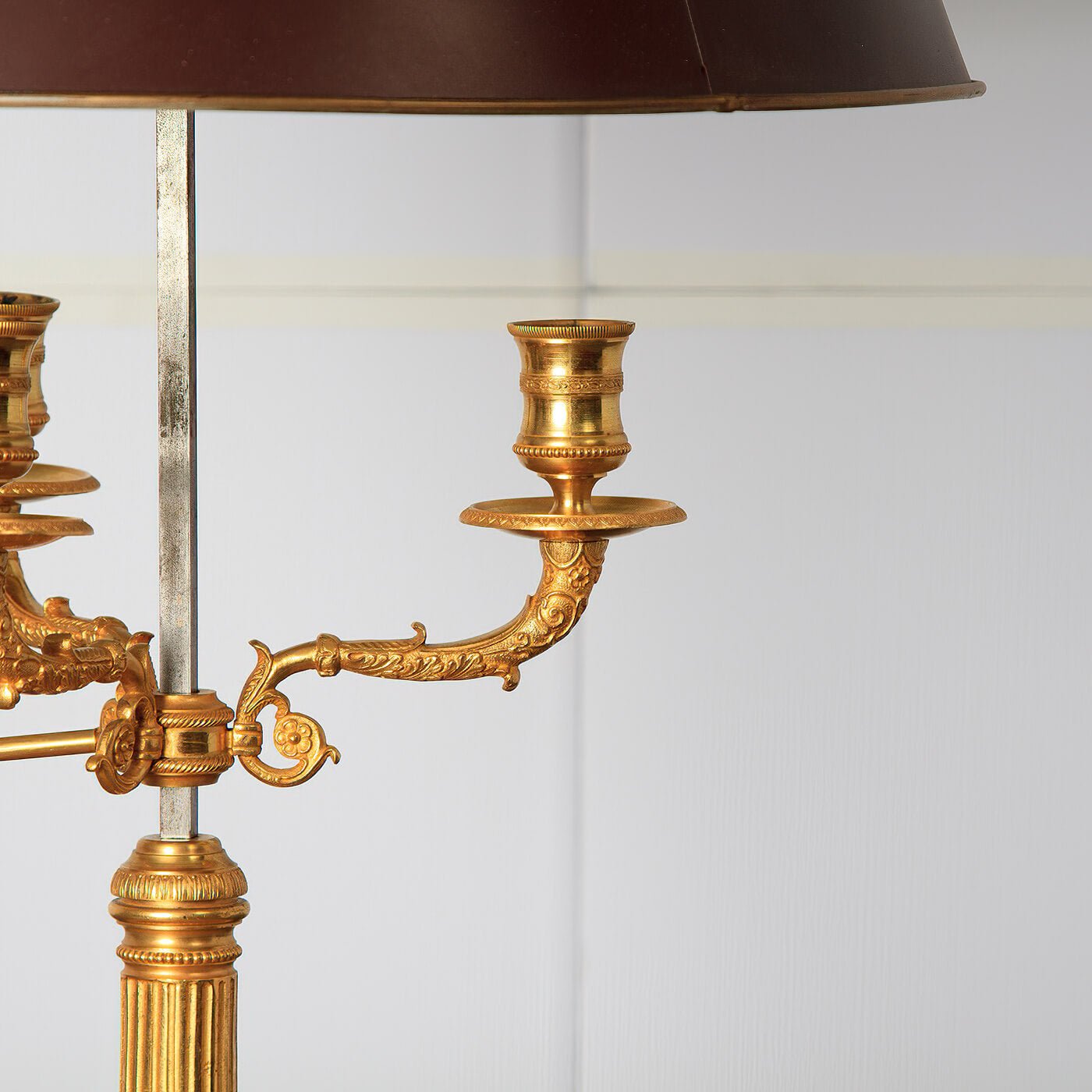 Close-up of lamp's detailed gold candle holders.
