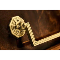 Close-up of French Louis XVI console handle design.