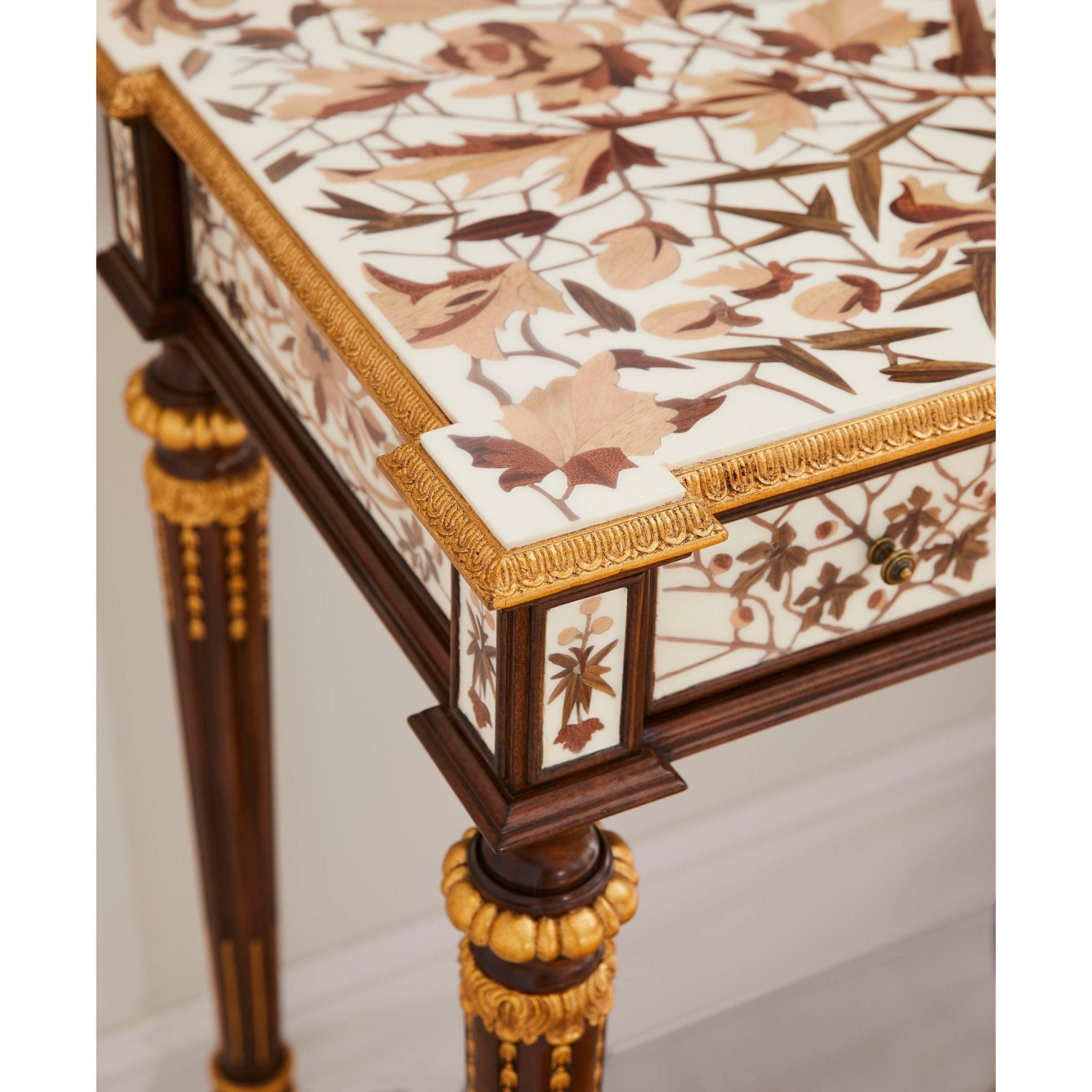 Corner detail of French console table with floral inlay.