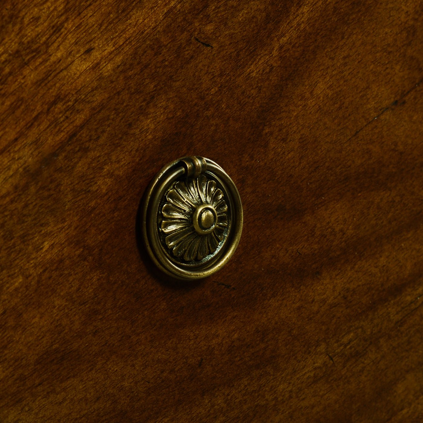 Close-up of French Louis XVI nightstand drawer handle.