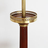 Top shelf of Louis XVI floor lamp with brass trim.