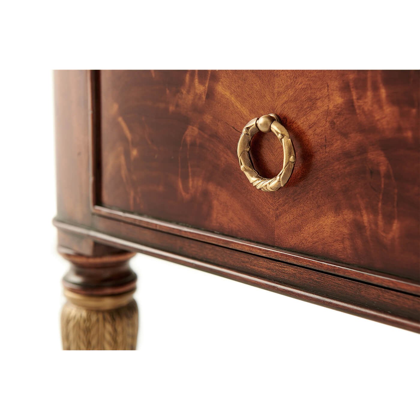 Drawer handle detail on French mahogany desk, elegant design.