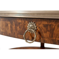 Detailed view of mahogany cocktail table's decorative sun motif.