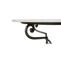 Close-up of marble tabletop edge and metal scrollwork.