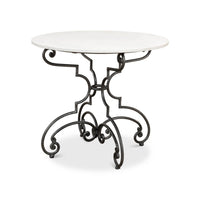Round table with marble top and ornate metal base.