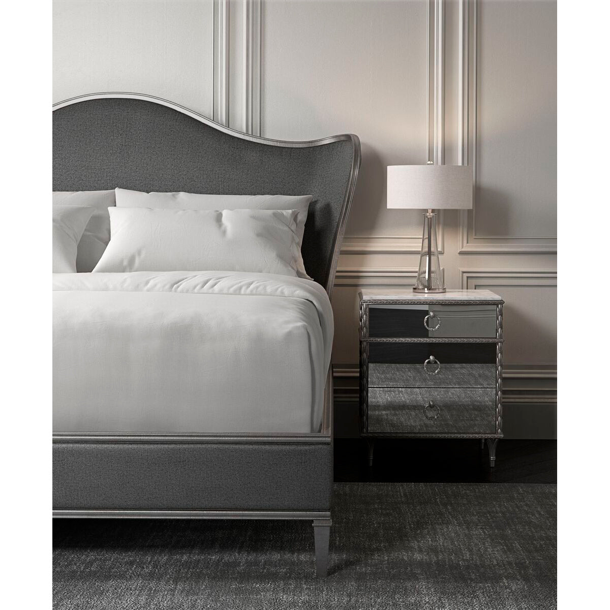 Mirrored nightstand beside bed, modern bedroom setting.