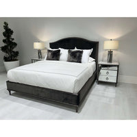 Bedroom with dual mirrored nightstands and stylish bedding.