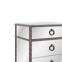 Close-up of mirrored nightstand with intricate details.